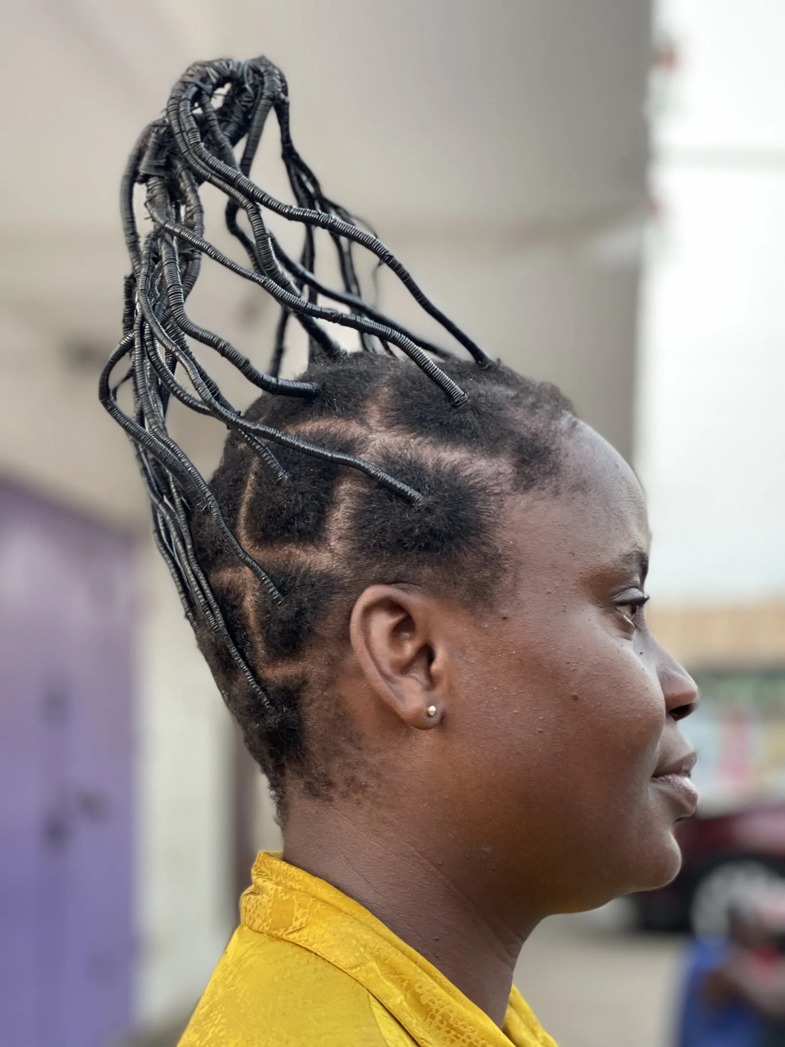 A Ghanaian lady with a plaited hair called 'Adonko Hair style' or 'Watchman's Wife'
