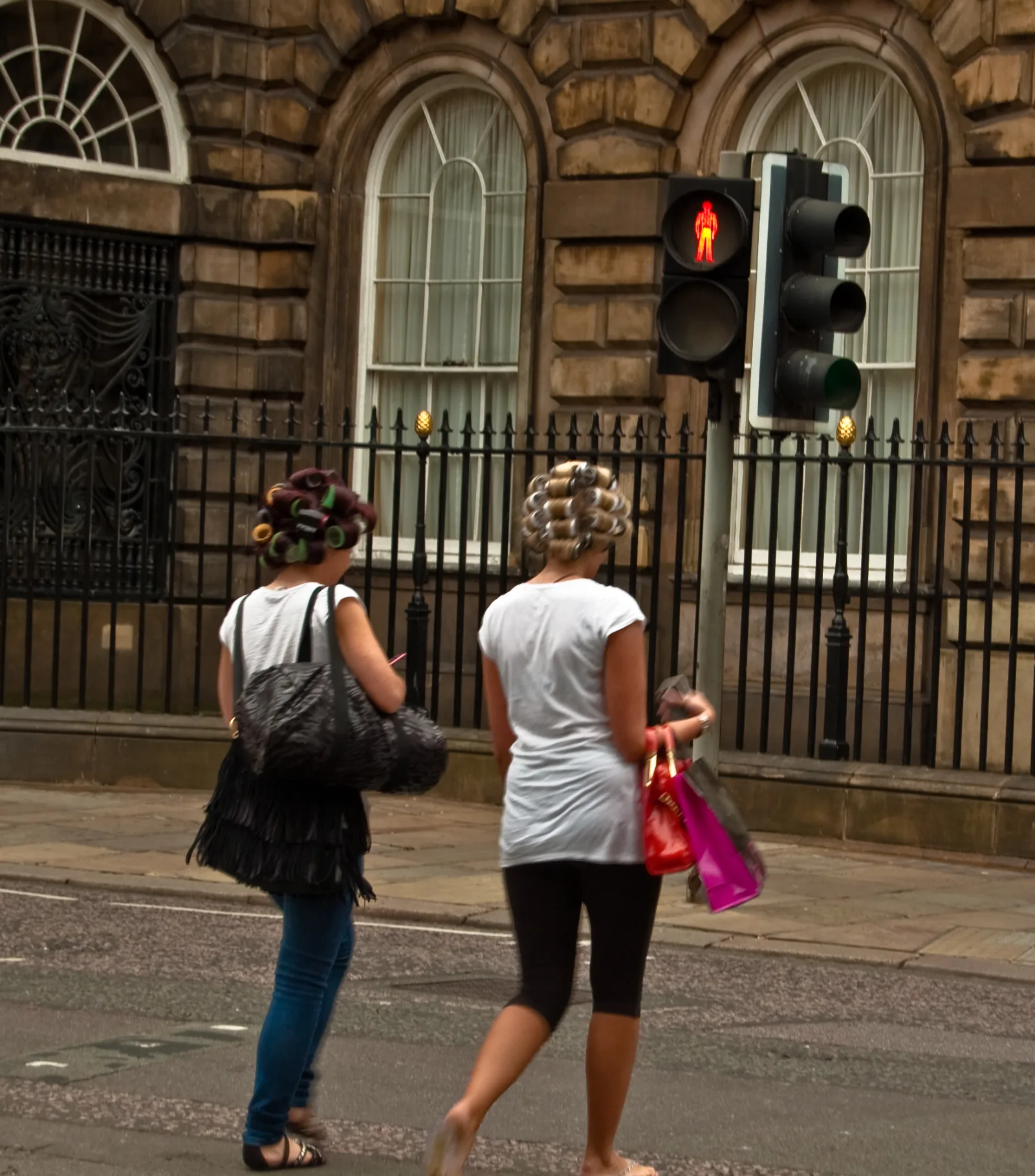 Women wearing curlers on crossing street in Liverpool.

"Whilst tourists entered into the spirit of Beatles Day in Liverpool by wearing Beatles wigs, others were more mindful of the night out. Hilda Ogden eat you heart out."