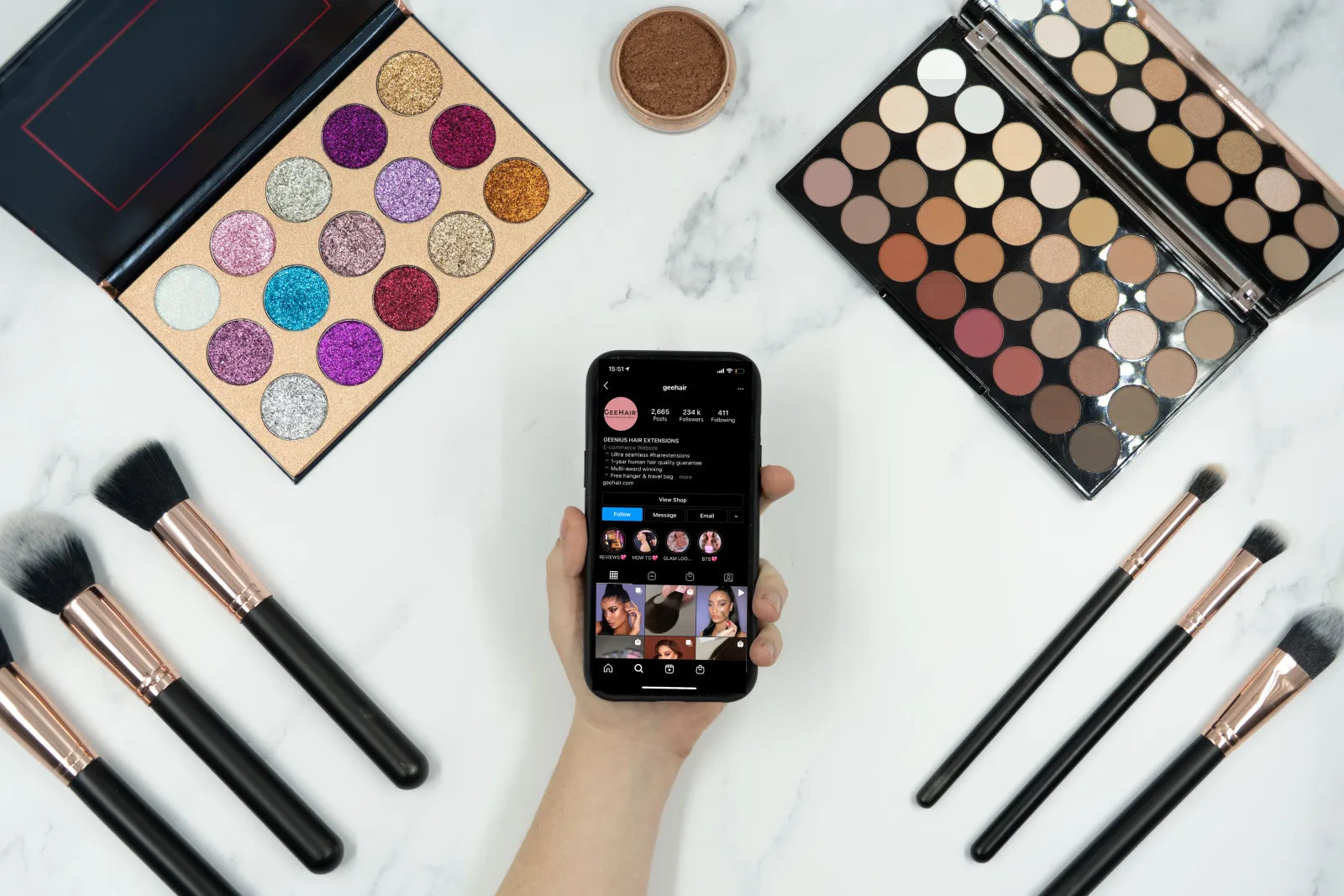 This photo shows someone using Instagram to watch and follow along with a make up tutorial. A selection of make up brushes and eyeshadow palettes can be seen around their phone. We've now made the decision to release this photo under Creative Commons so you can use it too! Just remember to credit us with a link to geehair.com/