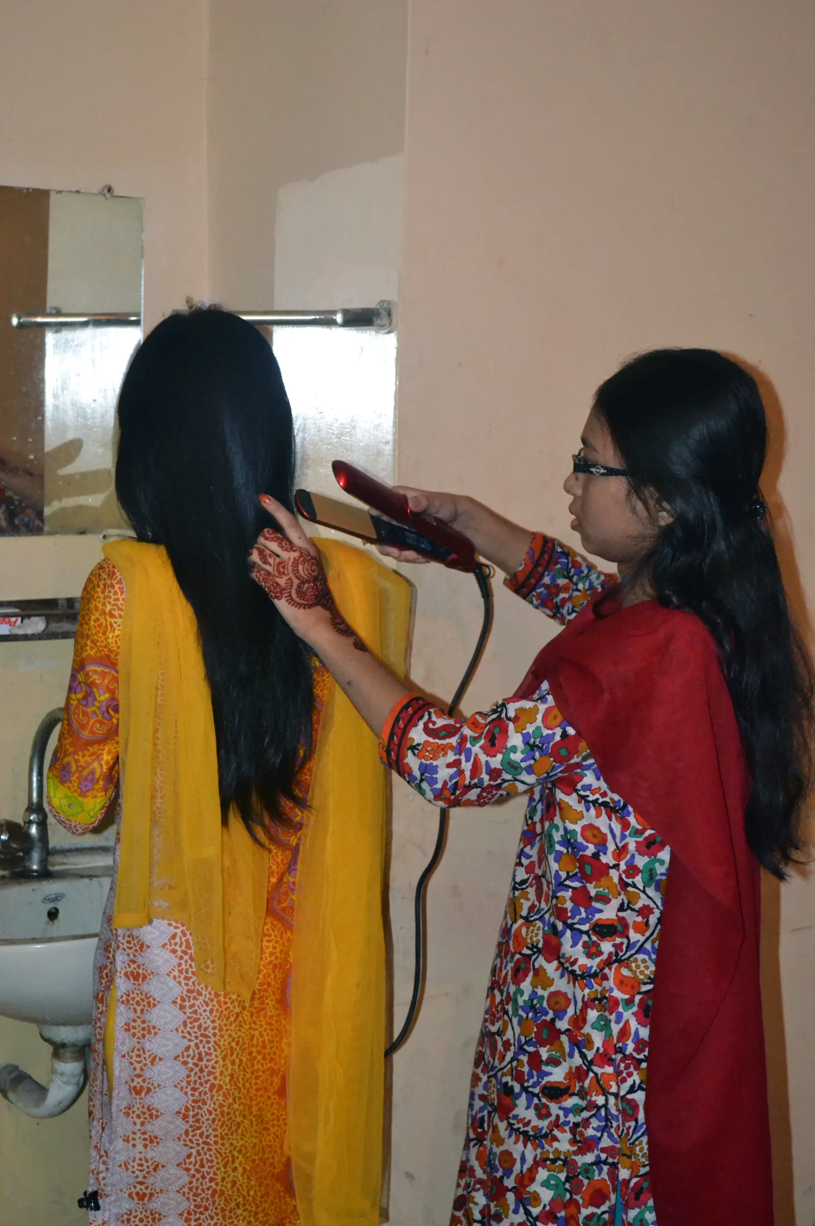 Hair being straightened with a flat iron