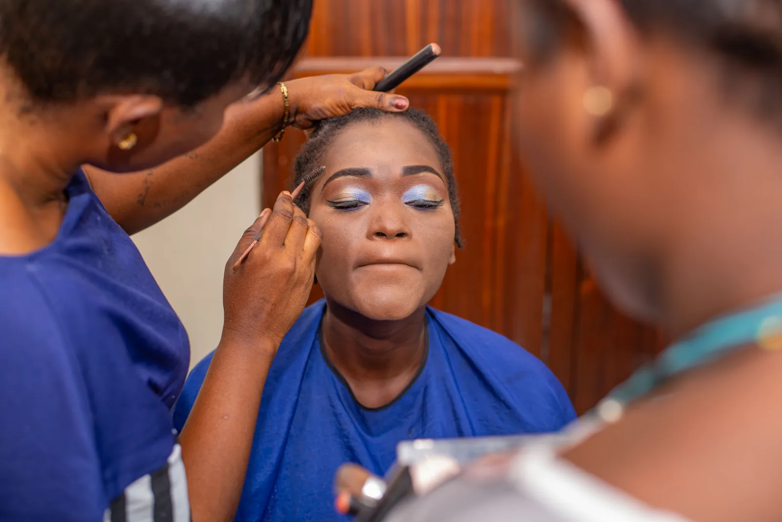 Makeup artist working on a woman.