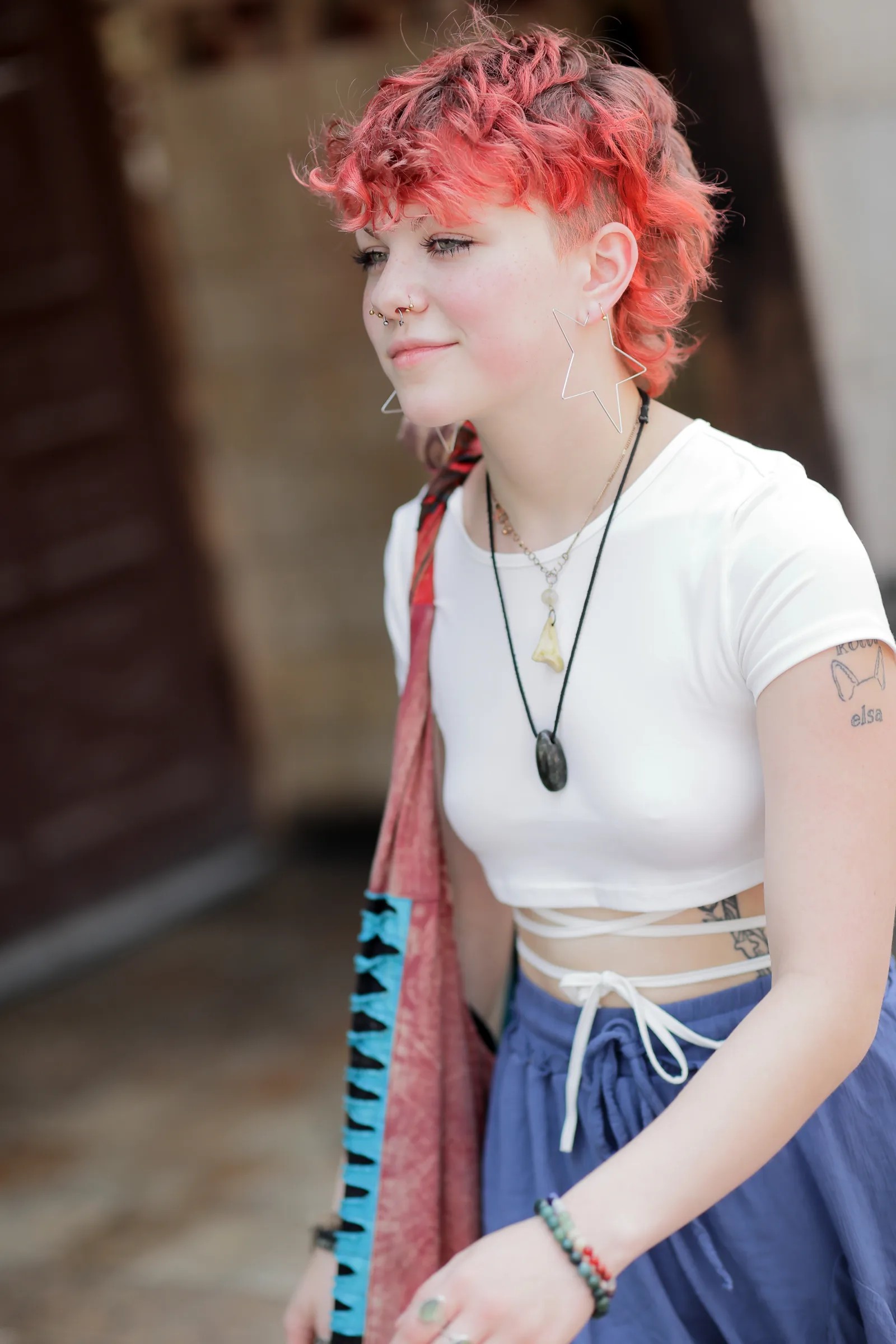 Young woman with short red hair and bohemian style in Madison, Wisconsin 2023