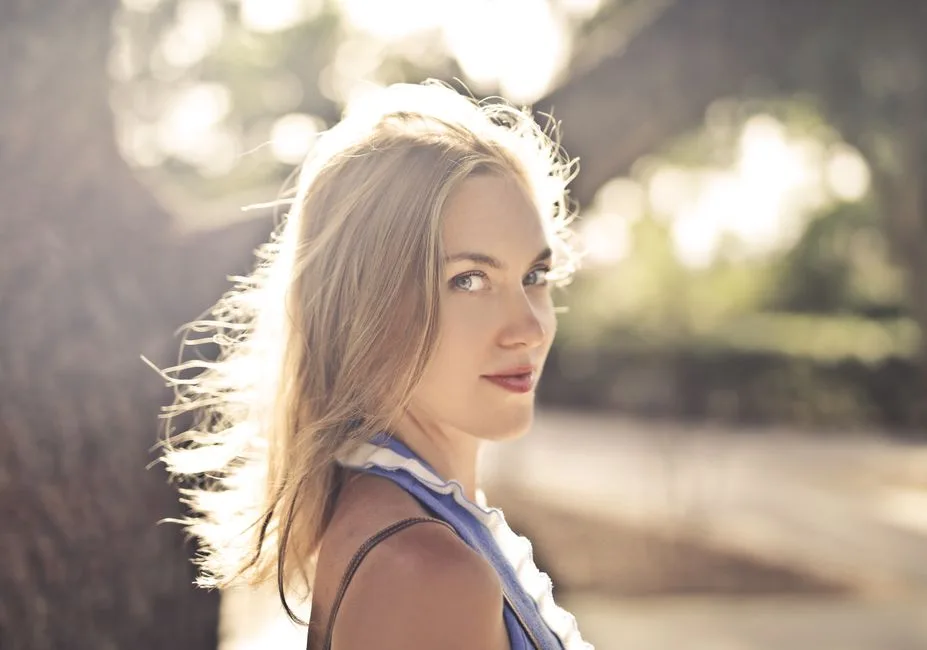 Beautiful portrait of a smiling woman in summer light outdoors.