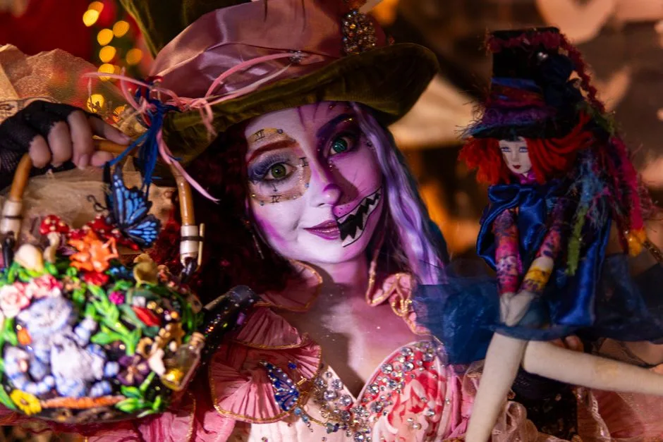Colorful fantasy cosplay featuring elaborate costume and artistic makeup, inspired by whimsical themes.
