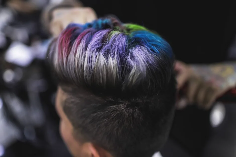 Close-up of a stylish multi-colored hairstyle showing vibrant rainbow hues, capturing modern hair artistry.