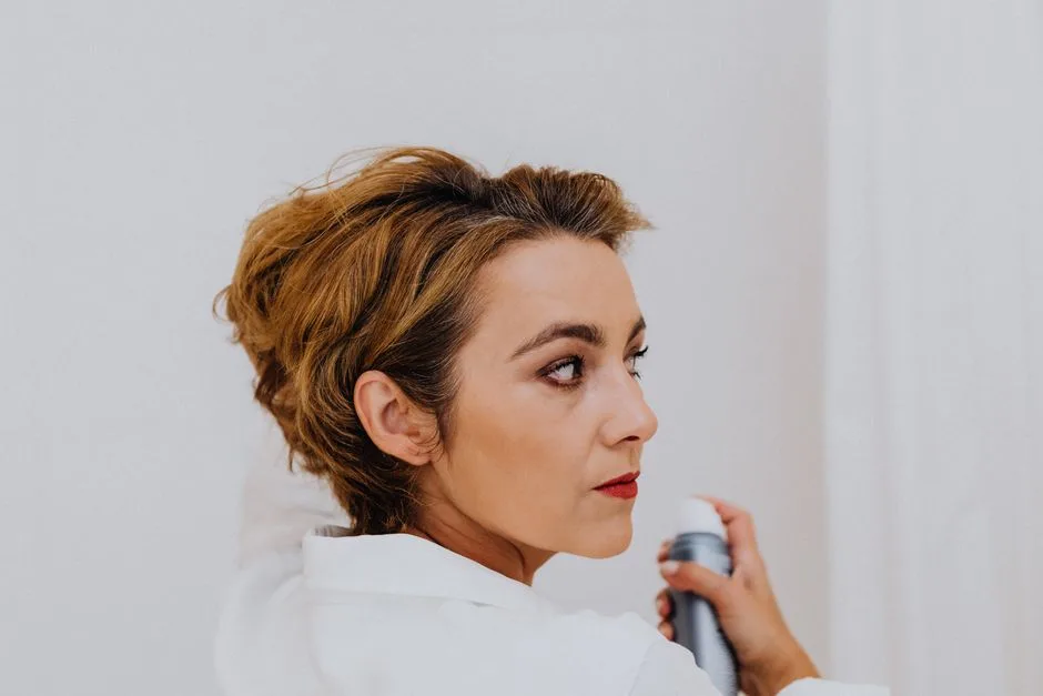 Side view of a mature woman applying hairspray with elegance. Perfect for beauty and style themes.