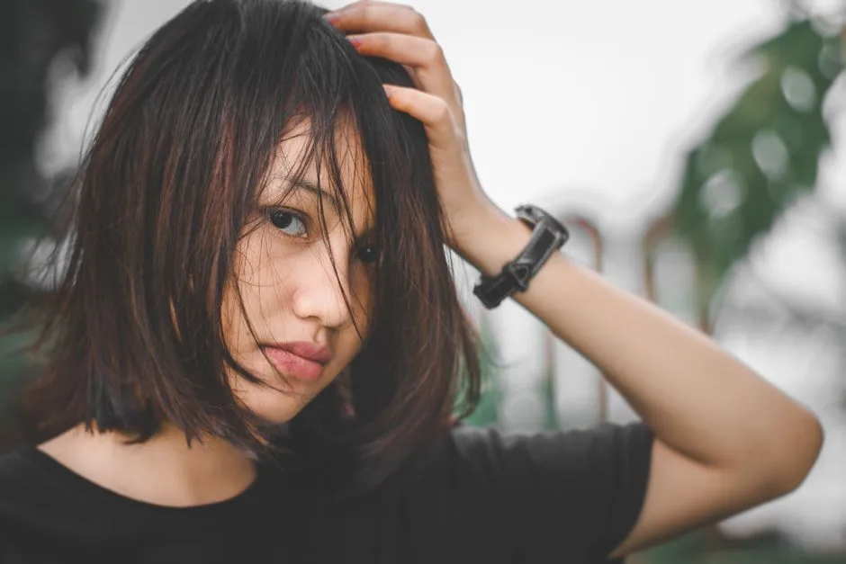 Close-up portrait of a young woman with messy hair, outdoors in Banten, Indonesia.