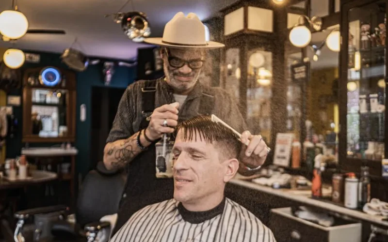 A classic barbershop scene with a barber styling a customer's hair, capturing nostalgic grooming moments.