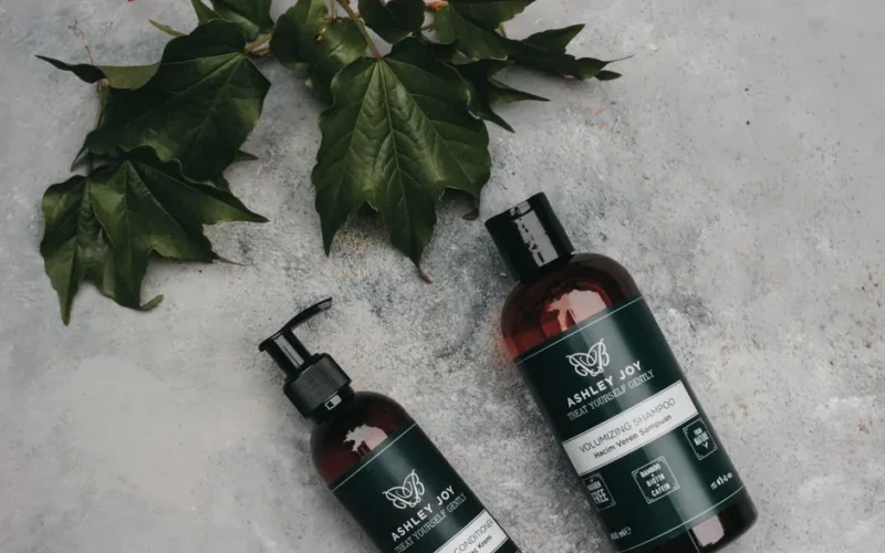 Natural volumizing shampoo and conditioner with green leaves for organic hair care.