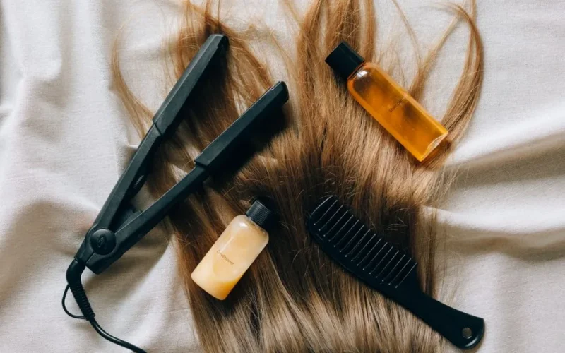 Aesthetic flat lay of hair products and tools for styling and grooming.