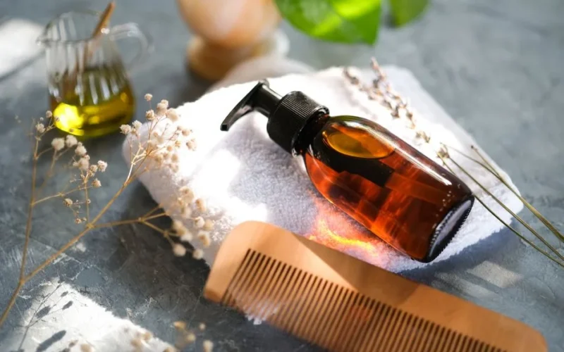 Elegant display of hair care accessories with natural elements and a wooden comb.