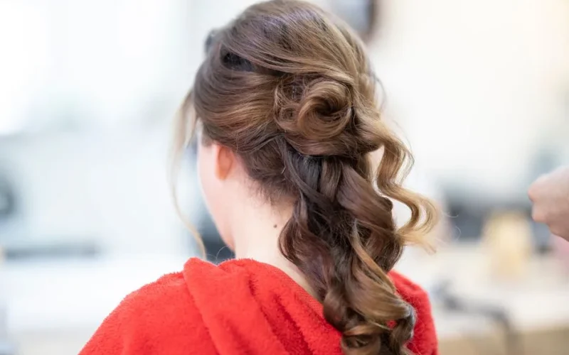 Close-up of an elegant bridal hairstyle featuring curls and a braid, captured from the back.