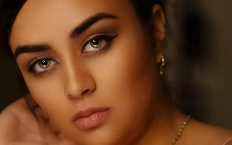 A close-up portrait showcasing a woman's elegant makeup and serene expression.